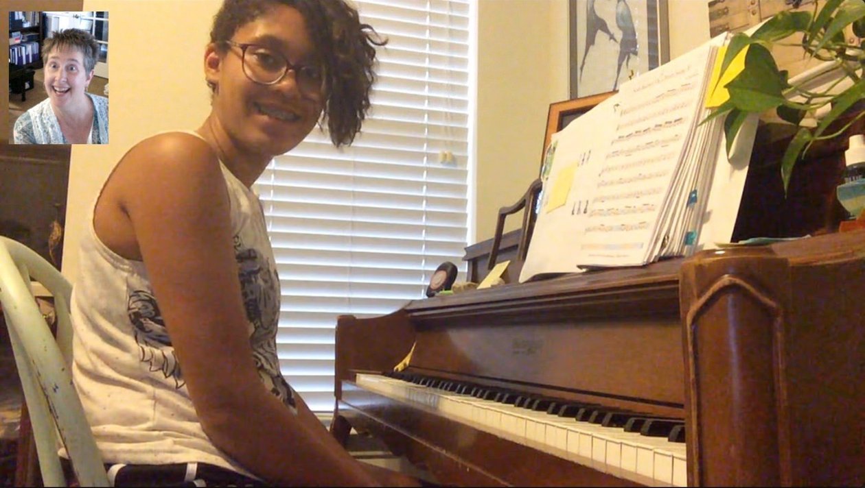 Young piano student practicing at the keyboard during a lesson in Monument, CO